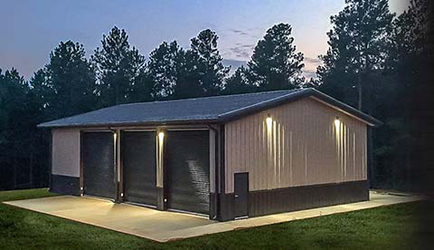 Modern metal building with professional lighting at dusk